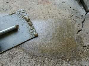 Epoxy sand slurry for repairing spalled garage floors