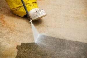 cleaning garage floor with pressure washer